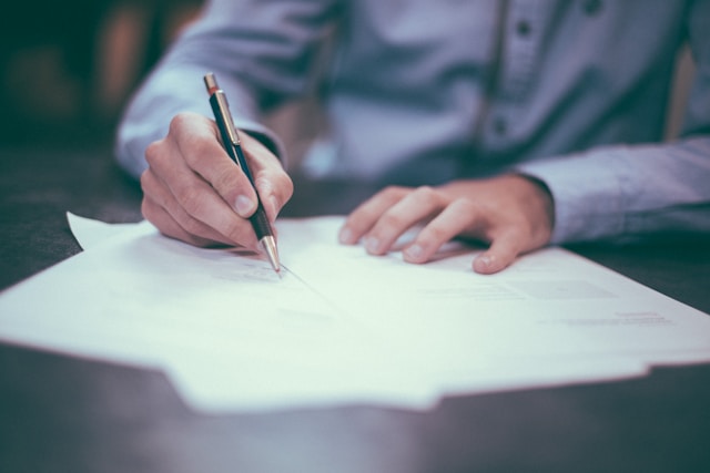 A man writes on a piece of paper