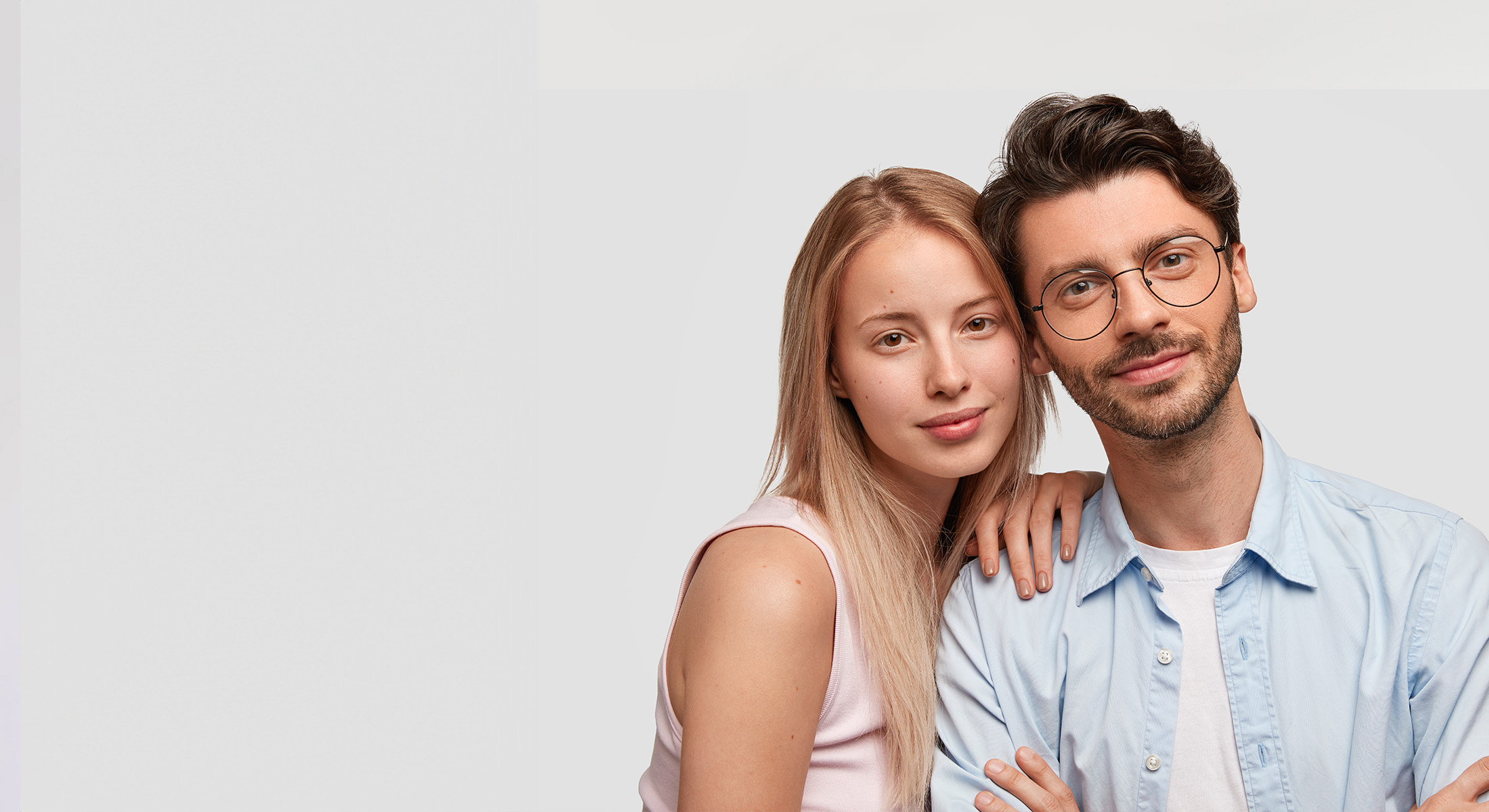 A young couple smiles at the camera