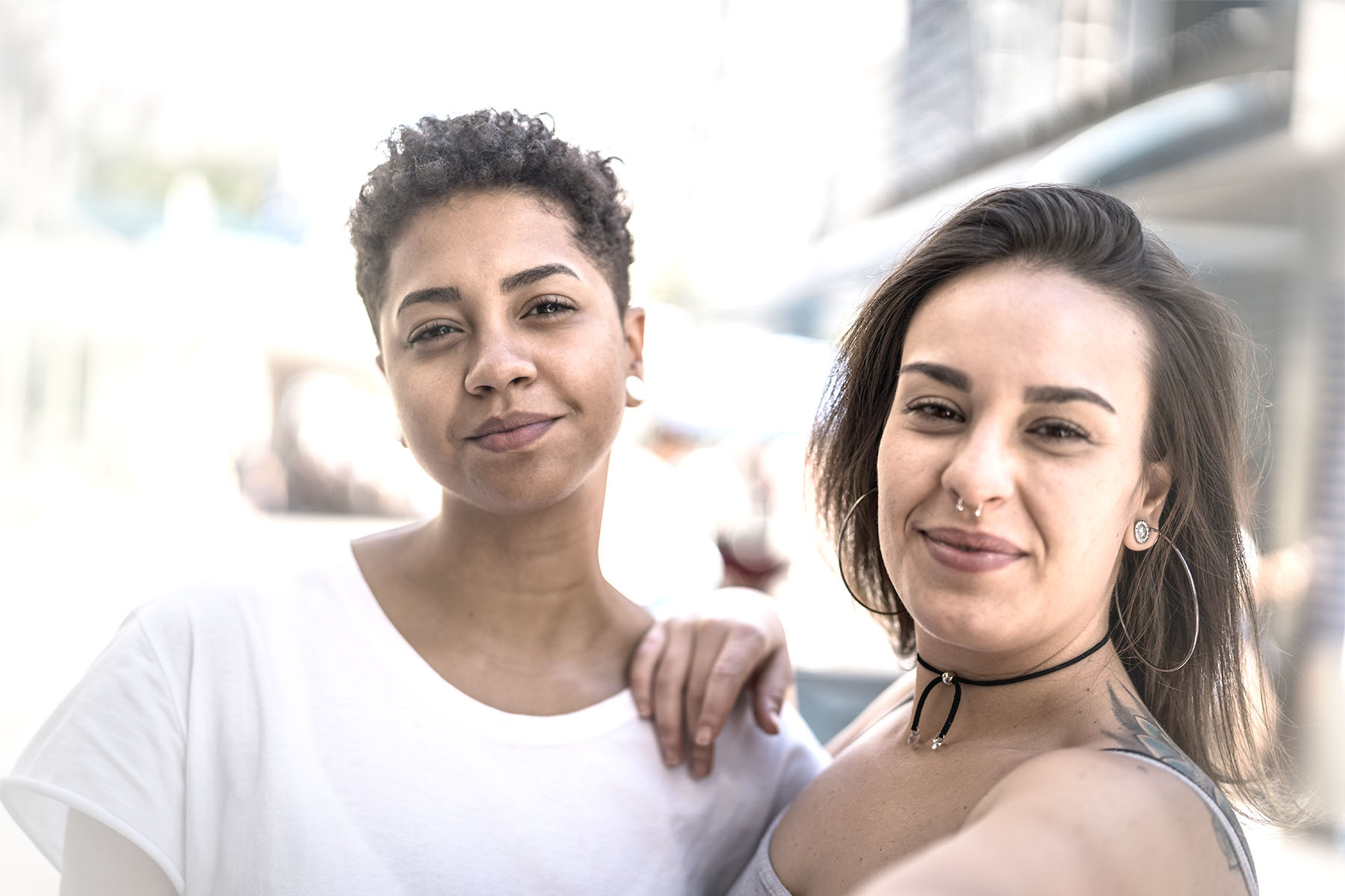 Two women smile into the camera